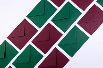 Top view of green and red envelopes on white background. Post flat lay. Copy space.