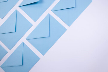 Top view of light blue envelopes on white background. Post flat lay. Copy space.