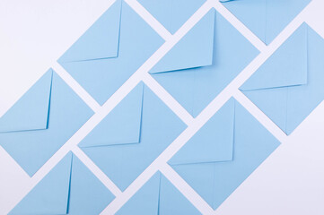 Top view of light blue envelopes on white background. Post flat lay. Copy space.