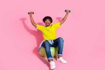 Photo of cheerful funny strong latin man wear stylish yellow clothes raise muscular arm isolated on pink color background