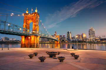 Cincinnati, Ohio, USA. Cityscape image of Cincinnati, Ohio, USA downtown skyline with the John A. Roebling Suspension Bridge and reflection of the city in the Ohio River at spring sunrise. - 777219626
