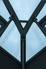 Detail of the metal structure supporting part of the inside glass roof of a modern building