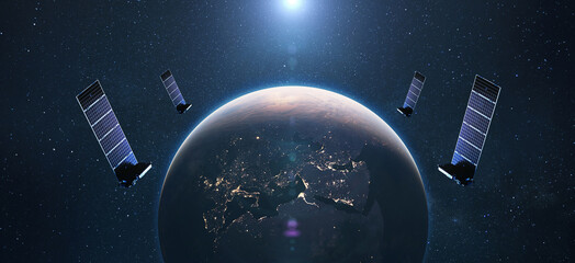 Satellites in orbit of planet Earth with the lights of the night cities of Europe. satellite...