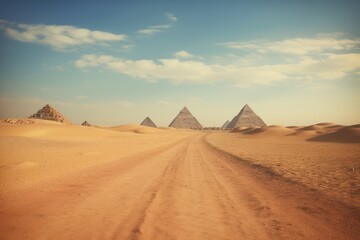 Desert landscape with the pyramids on the horizon.