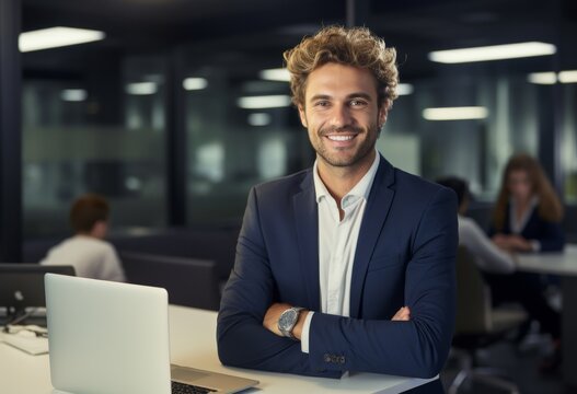 Portrait shot of a smiling professional businessman in neat suit outfits sitting at a desk using a laptop on a blurred modem office background. Generative AI.