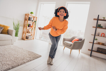Photo portrait of lovely young lady dance headphones have fun dressed casual orange clothes cozy...
