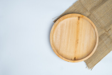 empty wooden plate with burlap cover, isolated