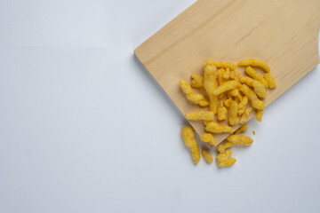 corn chips snack on wooden cutting board isolated on white background.