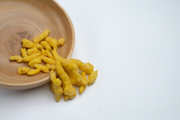 corn chips snack in wooden bowl isolated on white background.