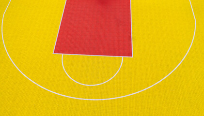 High angle view of red and yellow basketball court
