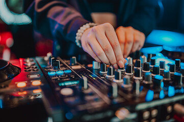 The vibrant energy of a live music performance is captured in this image, where a DJ’s skilled...