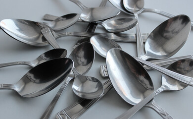 Variety Size Silvery Spoons On Clean White Surface. Concept Photo For Table Setting Illustration
