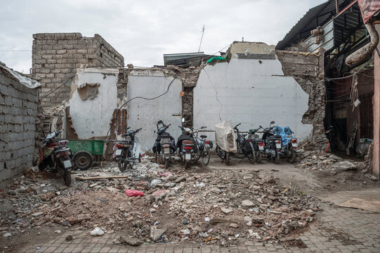 A ruin, inside the Medina in Marrakech, Morocco, left from the earthquake in 2023.  Bikes are using the building as a parking spot.