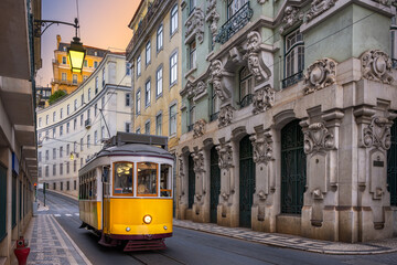 Yellow tram on a street with historic buildings in Lisbon, Portugal