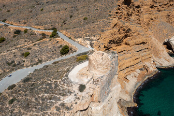 Aerial drone photo of an old rundown ruins of an old fort lookout in the town of Benidorm in Spain known as The Punta del Cavall Tower