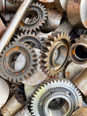 Steel cog wheels starting to rust on a scrap heap