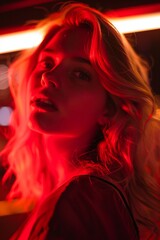 Portrait of a blonde woman in red light 
