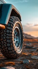 A rugged offroad tire with a sleek aluminum rim set against a backdrop of untouched