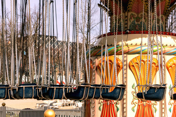 Carousel in an amusement park on a sunny day.