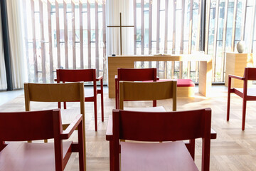 Church room for prayer and privacy with a large cross and chairs for visitors.