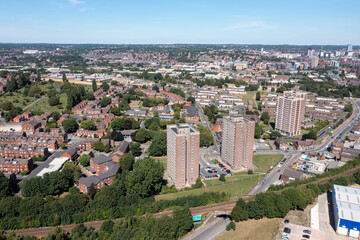 Aerial drone photo of the village of Wortley in Leeds, West Yorkshire in the UK showing houses estates and blocks of flats in the city by the train tracks. © Duncan