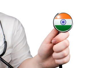 The head of a medical stethoscope in the form of an Indian flag in a hand (close-up) on a...