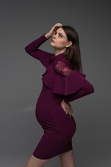 portrait of a pregnant woman, pregnant woman stands on a grey background close up, fashion pregnant model, pregnant woman stands on a grey background, studio shoot