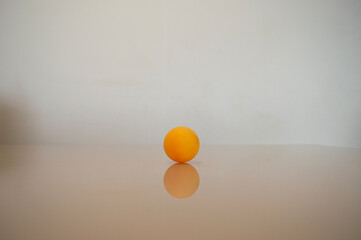 a yellow ping pong ball on a table