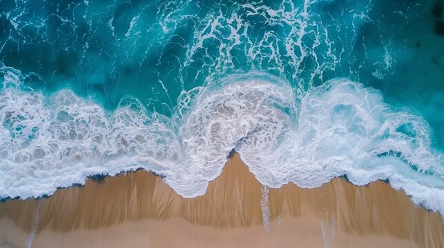 Aerial view of ocean waves meeting the sandy shore, capturing the essence of a vibrant summer beach.