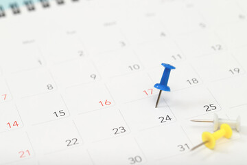 mark the event day with a pin. Thumbtack in calendar concept for busy timeline organize schedule,appointment meeting reminder. planning business meeting or travel holiday planning concept. soft focus