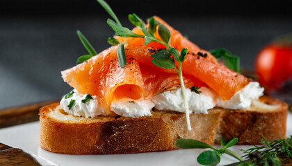 Close-up of toasted bread with smoked salmon and cream cheese. Tasty food. Delicious snack.
