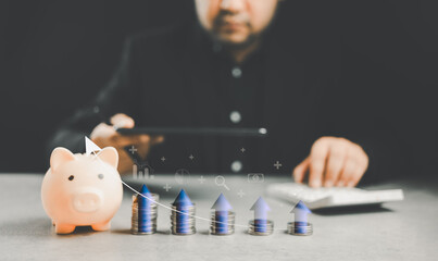 A piggy bank and a pile of coins lined up like a graph with icon finance plan and investing in the money market for interest returns with businessman analyze and calculate investing in the money marke - obrazy, fototapety, plakaty
