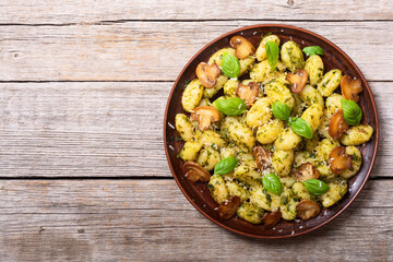 Homemade potatoes gnocchi with basil , cheese and mushrooms