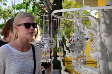 Foreign traveler and thai people travel visit respect praying blessing wish mystical worship holy ancient buddha at Wat Rong Khun or Chiangrai White Temple on February 24, 2015 in Chiang Rai, Thailand