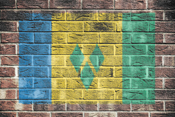 Saint Vincent and The Grenadines flag on old brick wall background - obrazy, fototapety, plakaty