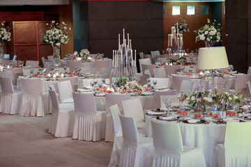 White color wedding table decorated with decorative and elegant for wedding. There are flowers,...