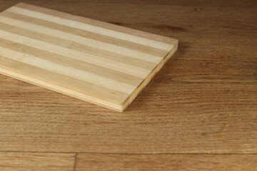 Empty wooden cutting board on wooden table. 