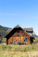 Olden wooden house at the meadow.