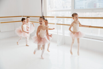 Child ballerinas, little girls in mid-dance, capturing dynamics of ballet lesson. Classical ballet...