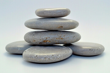 Fototapeta na wymiar Zen Stones Piled in Harmony, Beach Background, Concept of Meditation and Balance, Tranquil Spa Setting