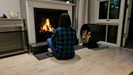 Woman Sitting on the Floor by Fireplace