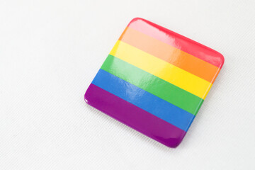 A rainbow icon (a symbol of the LGBT movement) is attached to the T-shirt