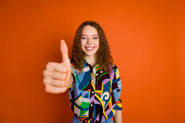 Photo of lovely nice girl wear stylish clothes thumb up isolated on vivid orange color background