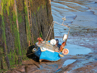 Blue Boat falling dry at low tide