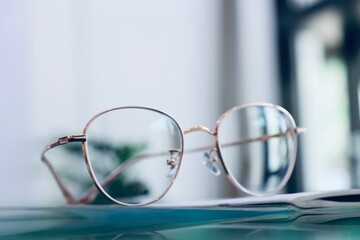 glasses on a table, Eyeglasses on table, progressive lenses, eyeglasses for the elderly, glasses progressive lens, eyeglass progressive lens, close-up of glasses on lenses test, looking through glasse - obrazy, fototapety, plakaty