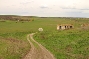 A dirt road leading to a house