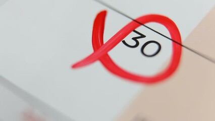 The 30th day is marked in the calendar with a red marker. Round date. Reminder. End of the month on the calendar. Macro. Free space for text.