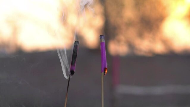 happy diwali slow motion fire cracker blowing with orange blurred background, sparkles slow motion from fire cracker