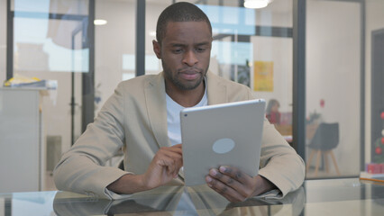 African Man Doing Video Talk on Digital Tablet in Office