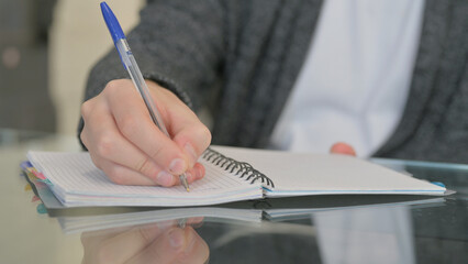 Close up of Man Writing a Diary